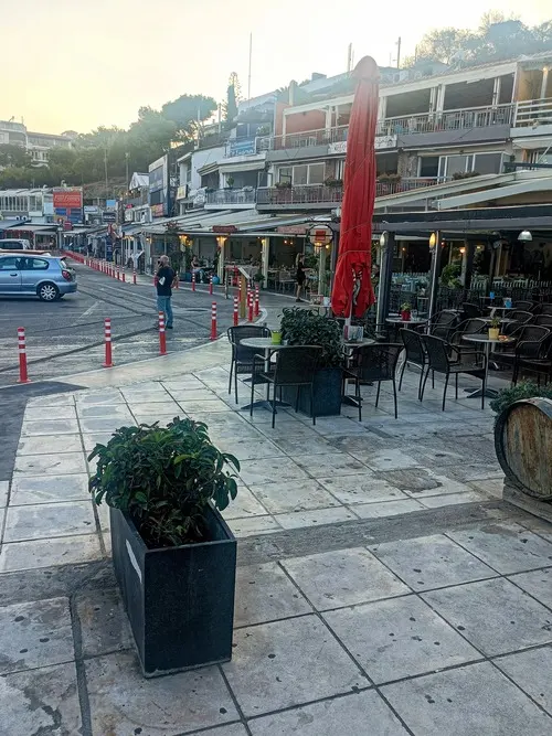 A table of fresh Greek seafood and meze by the water at sunset in Rafina