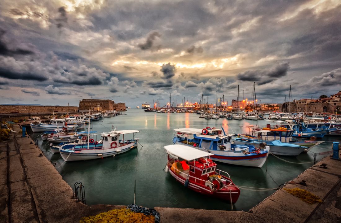 Sunset over Rafina harbour and waterfront tavernas